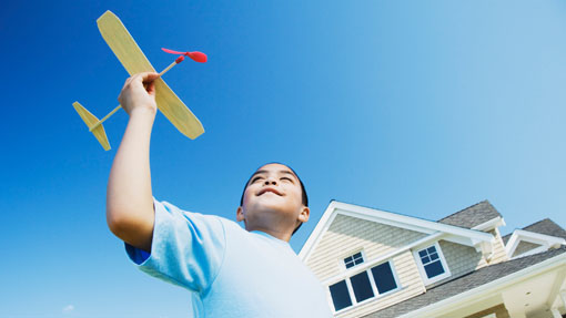 Boy playing with aeroplane